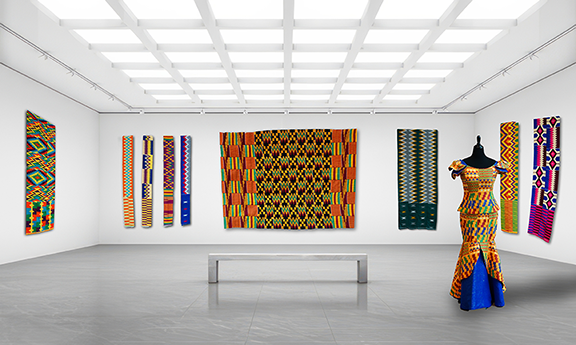 Gallery installation view of multiple handwoven Kente textiles from Ghana displayed on white walls, with a mannequin wearing a kente patterned peplum blouse and long skirt and a bench centered in the space.