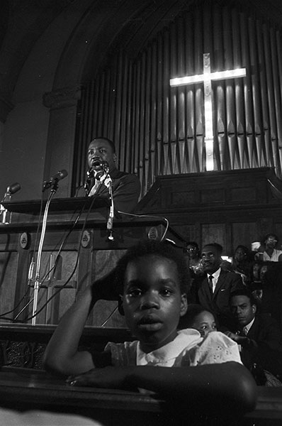 Spider Martin, White hecklers confront civil rights marchers from behind a Confederate flag, AL, 1965; photograph, 9 x 13 1/2 inches; © Courtesy James