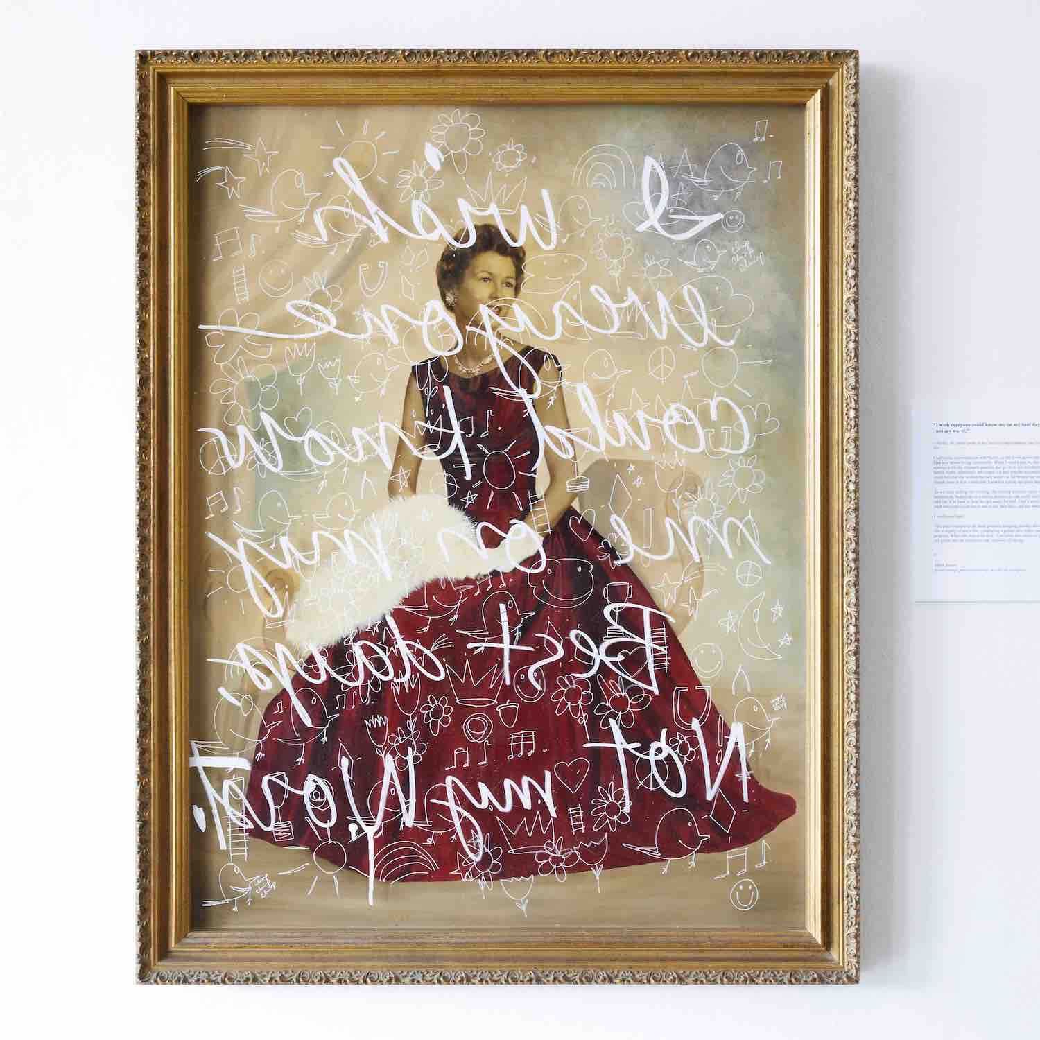 A gold-framed vintage photo of a woman seated in a red ballgown. The words “I wish everyone could know me on my best days, not my worst” are written in white cursive letters on the inside of the glass, so the words read backwards to the viewer.