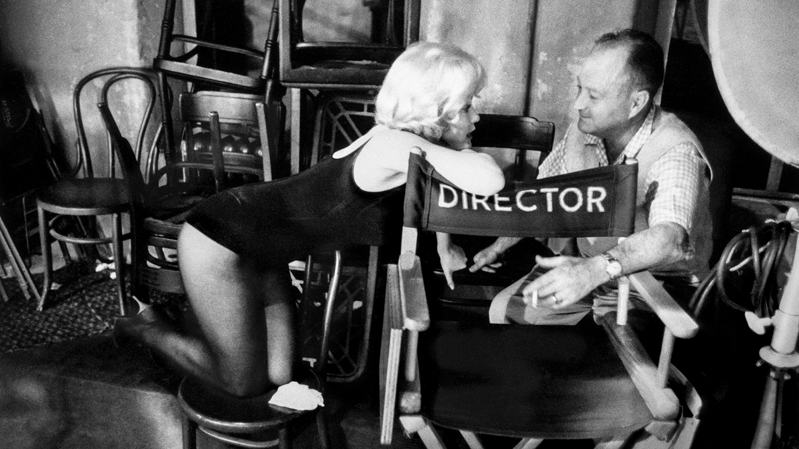 Marilyn Monroe talking to the camera operator on the set of ‘Let’s Make Love,’ 20th Century Fox