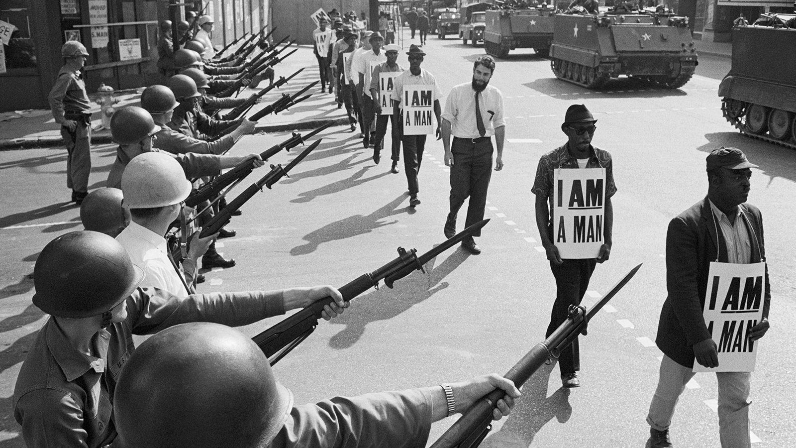 Unknown, U.S. National Guard troops block off Beale Street as Civil Rights marchers wearing placards reading I AM A MAN pass by on March 29, 1968, Memphis, TN,
